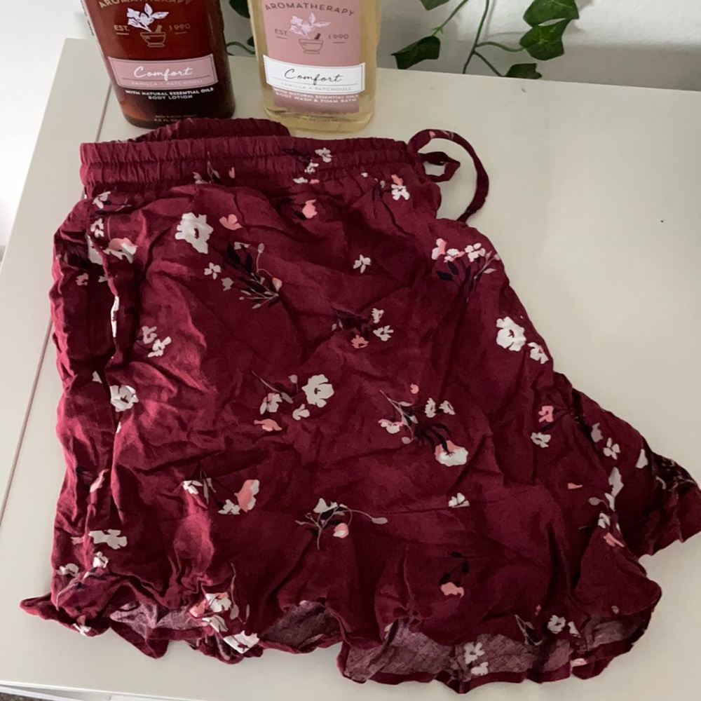Maroon floral shorts.